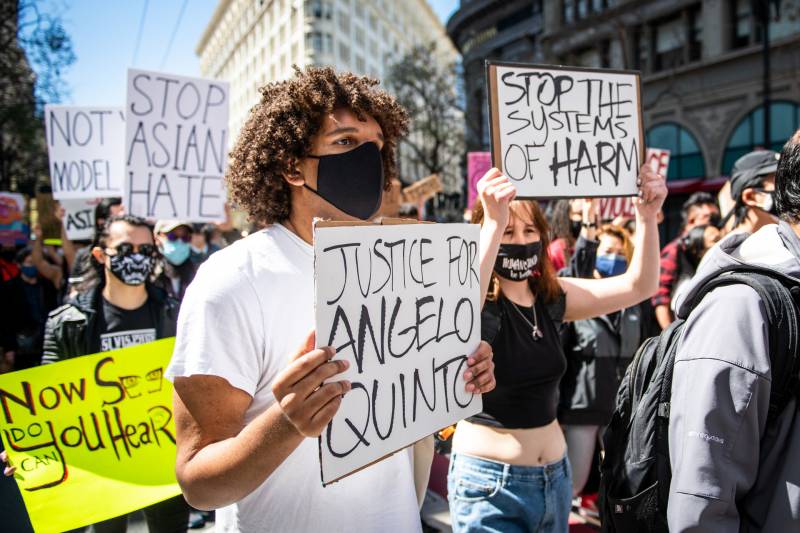 A demonstrator holds a sign that says, 'Justice for Angelo Quinto' during a student-led rally to show solidarity with the Asian American community and bring awareness to the death of Angelo Quinto, in San Francisco on March 26, 2021.