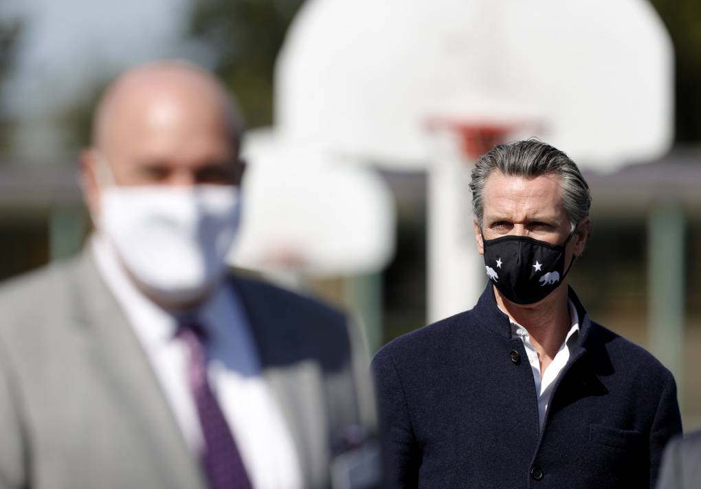 Gavin Newsom with mask on school's basketball court