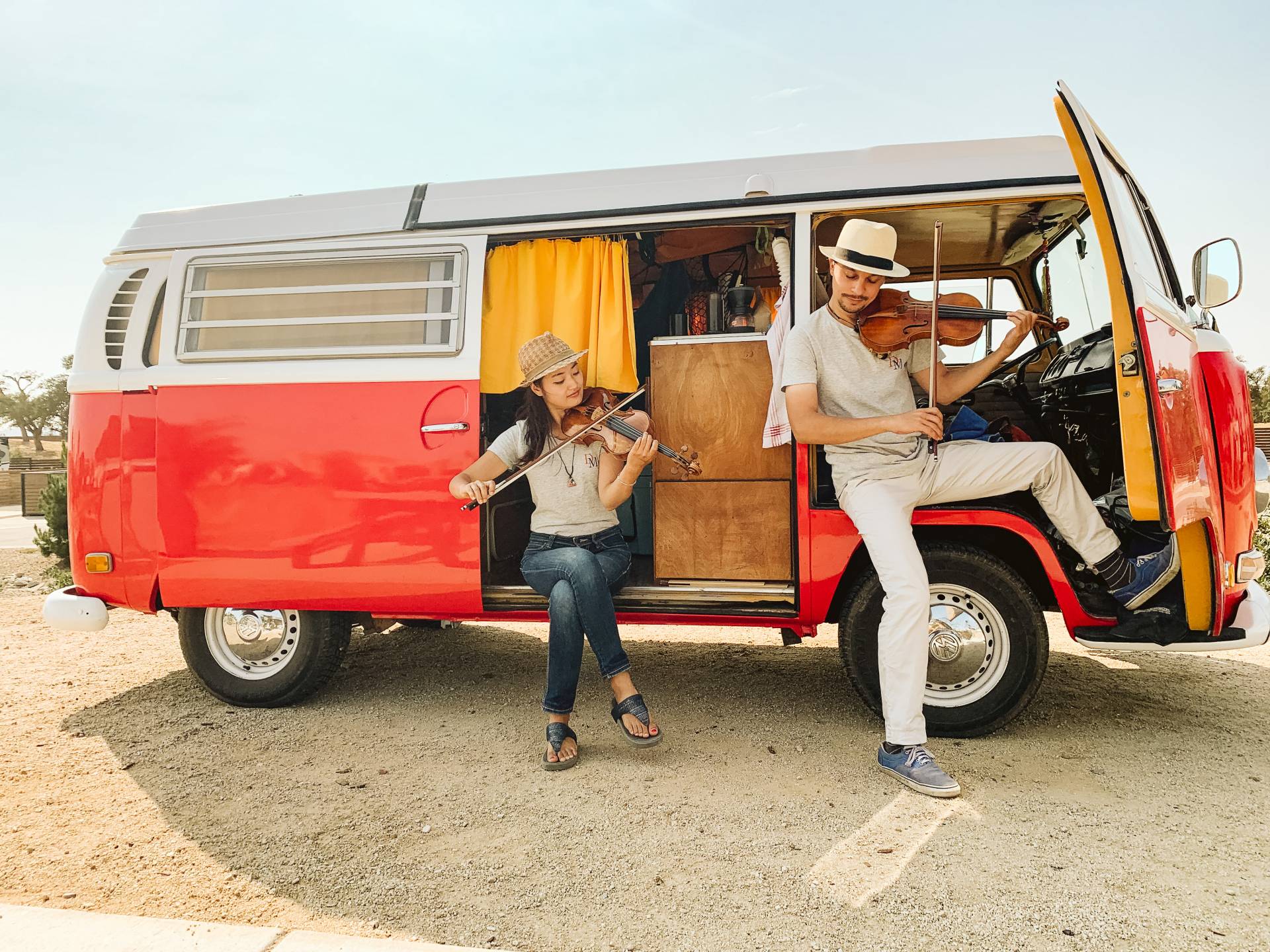 MusiKaravan violinists Etienne Gara and YuEun Kim in Paso Robles with their bright red 1971 VW bus named Boris. Courtesy Lathan J.