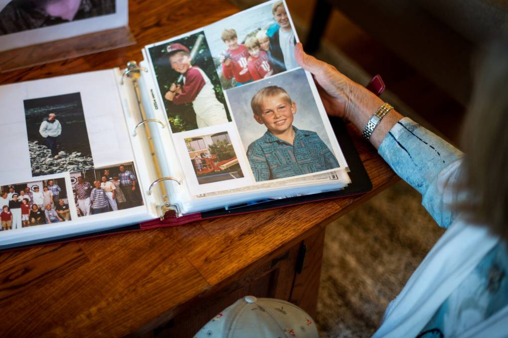 Robin Dosskey looks through childhood photos of her son Kyle at her home in Mountain View on May 12, 2021. Kyle died in 2019 due to a fatal dose of fentanyl. Beth LaBerge/KQED