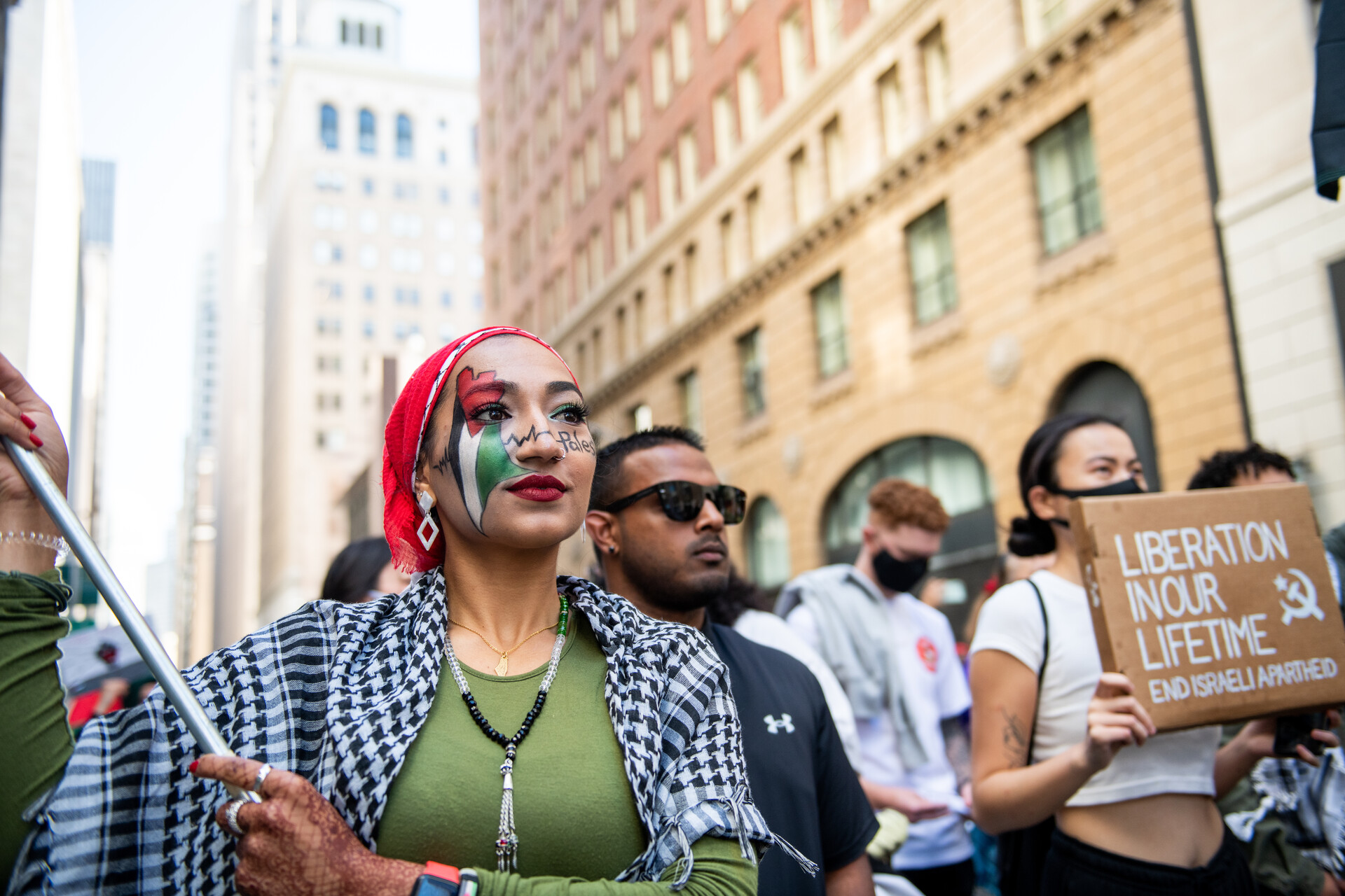 Safa Choudhury holds a Palestinian flag during a rally outside of the Israeli Consulate in San Francisco on May 18, 2021.