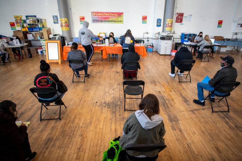 People wait for tax help at the Mission Food Hub in San Francisco on May 19, 2021.