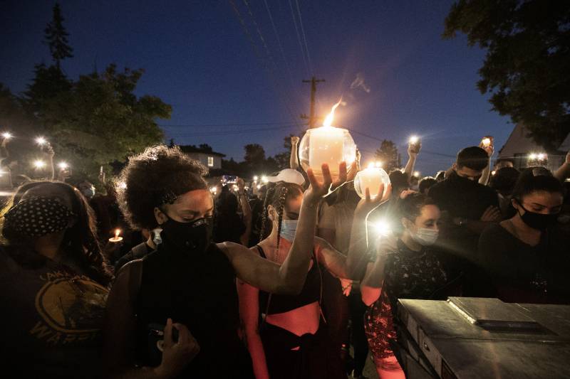 A candlelight ceremony at night to remember the death of George Floyd, who was murdered by a Minneapolis police officer.