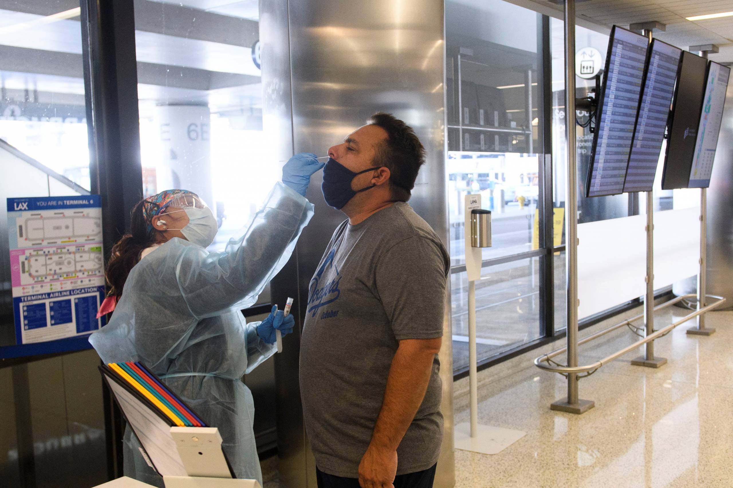 A traveler receives an in-airport Covid-19 nasal swab test a day before his flight to Hawaii at Los Angeles International Airport (LAX) in Los Angeles on Nov. 18, 2020.