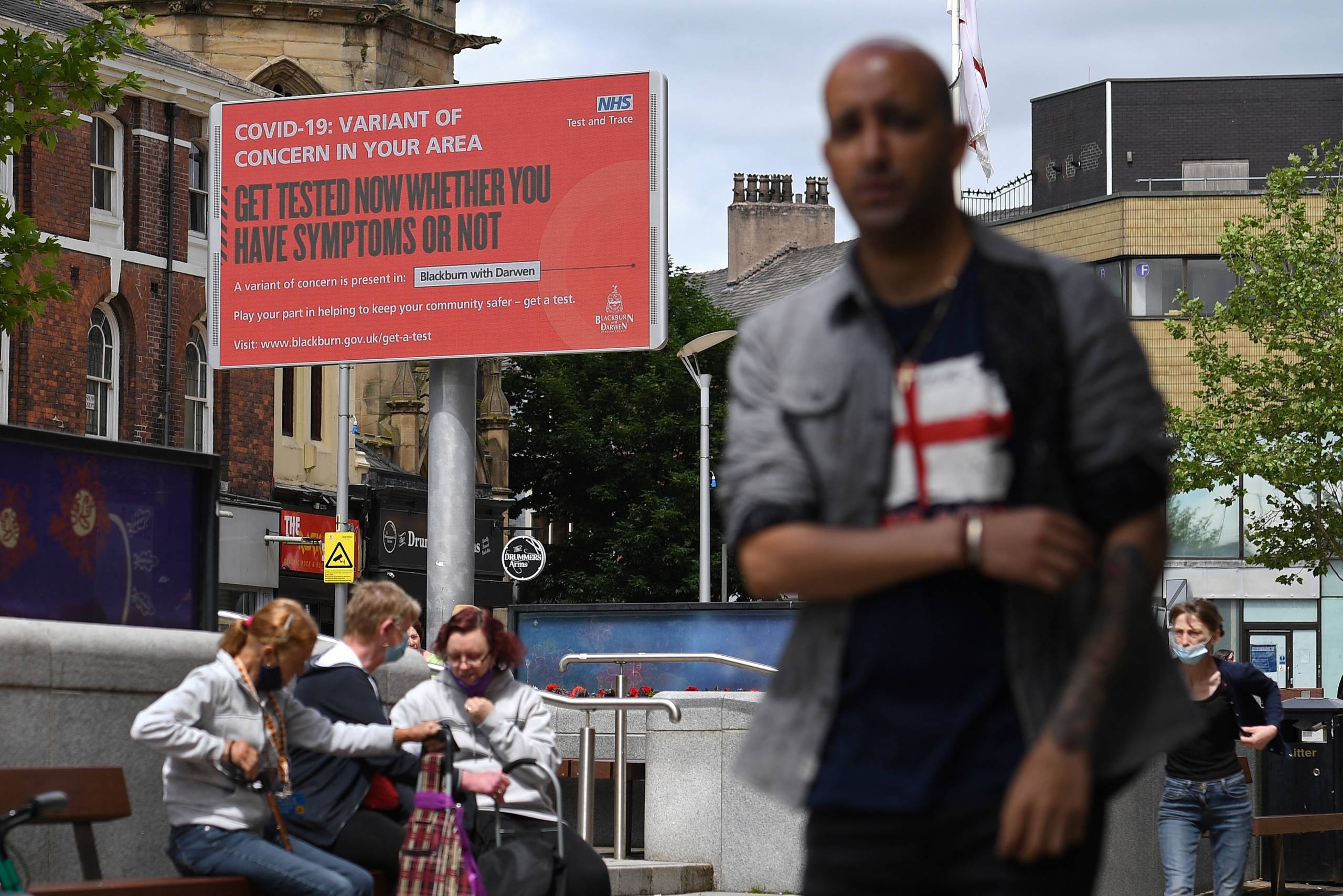 A sign urges people to get tested for a COVID-19 variant in Blackburn, England. The U.K. is experiencing a surge in the delta variant, which was first identified in India.