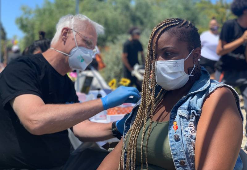 Roxanne Akins receives her second Covid-19 shot at vaccine pop-up clinic in Alameda.