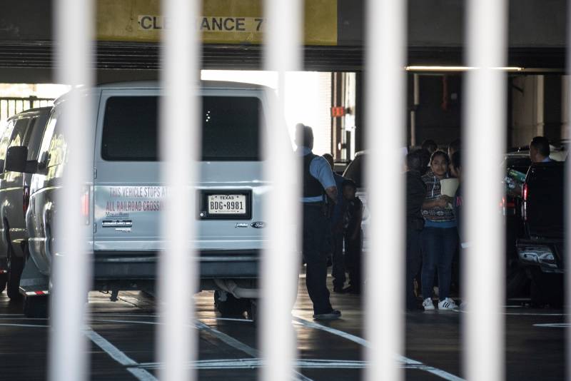 Migrants outside of a van at a federal building in El Paso, Texas