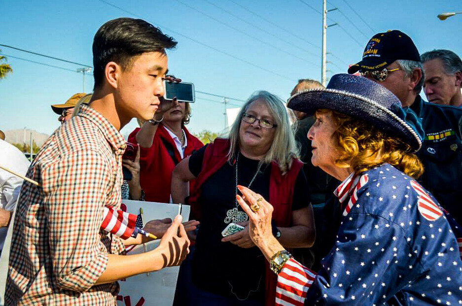 Ju Hong talking with a participant at an immigration rally.