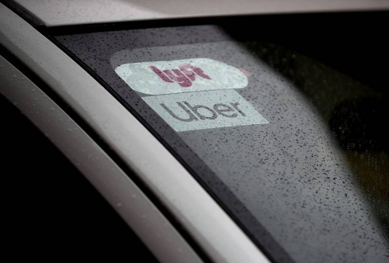 An Uber sticker in a car windshield.