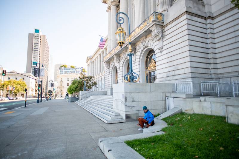 Gary McCoy sits outside of City Hall in San Francisco on Aug. 1, 2021, during a hunger strike calling for San Francisco to put funds toward the overdose crisis and implement safe consumption services.