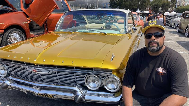 man with yellow lowrider car