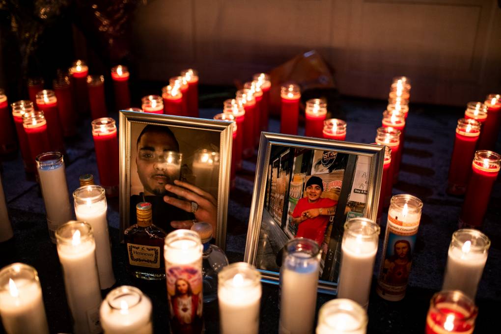 Lit candles surround two photographs.
