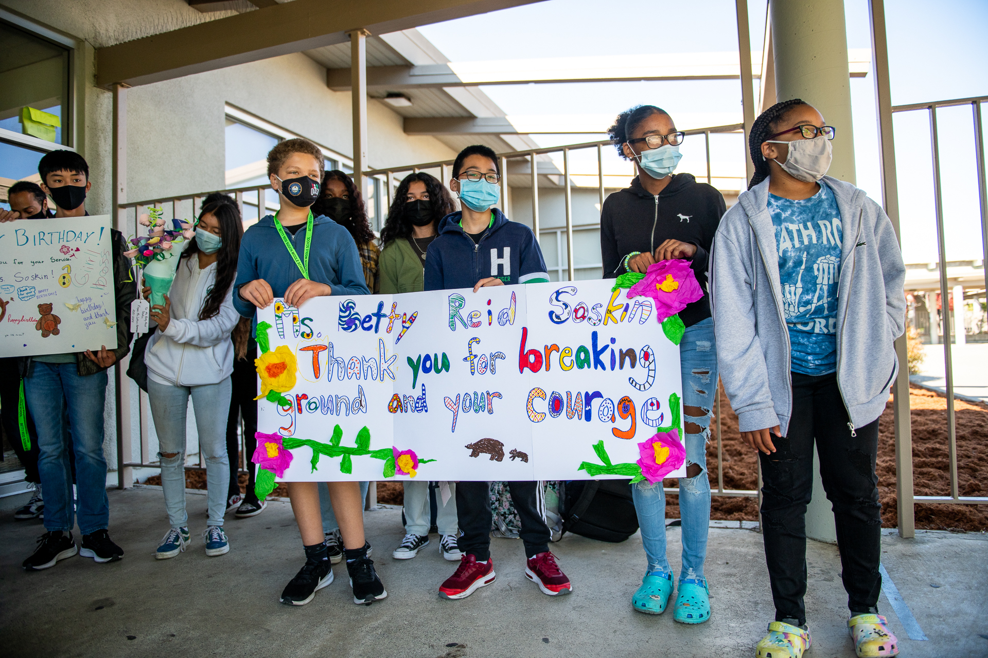 Masked students hold up signs thanking Betty Reid Soskin.