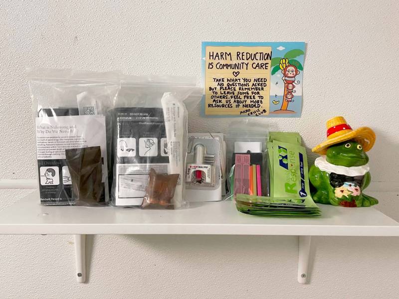 Fentanyl testing strips on a bathroom shelf, next to other health-safety products.