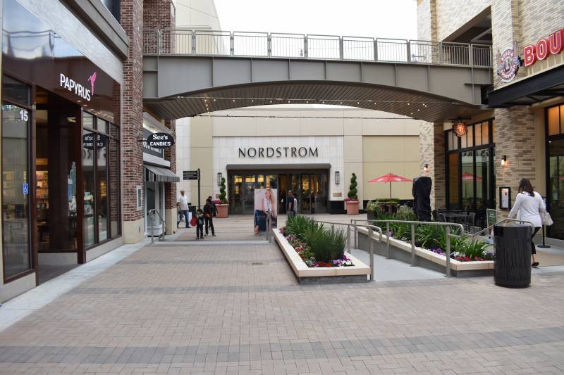 The entrance to a Nordstrom store in a shopping plaza.