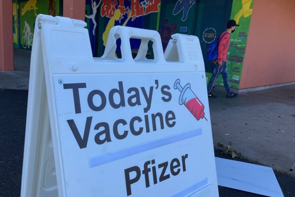 A close-up of a clamshell billboard that reads, "Today's vaccine: Pfizer."