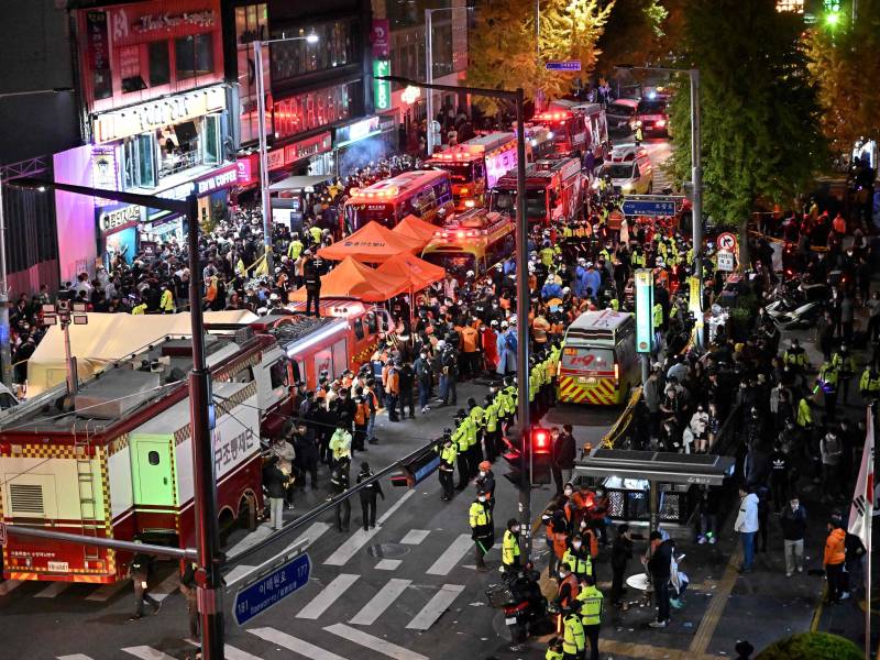 Crowds are seen around the area, where dozens of people suffered cardiac arrest, in the popular nightlife district of Itaewon in Seoul on Oct. 30, 2022.