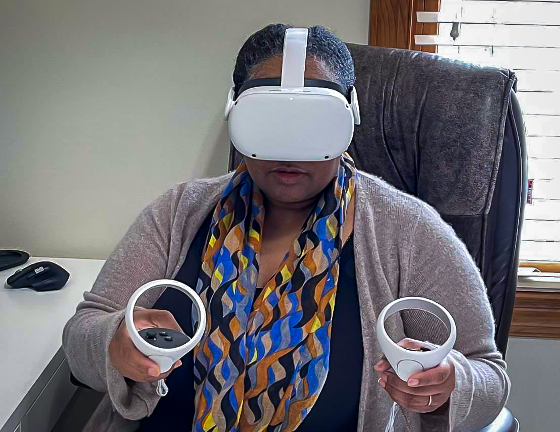 Behavioral Scientist Kelly Taylor, a Black woman, uses a VR headset