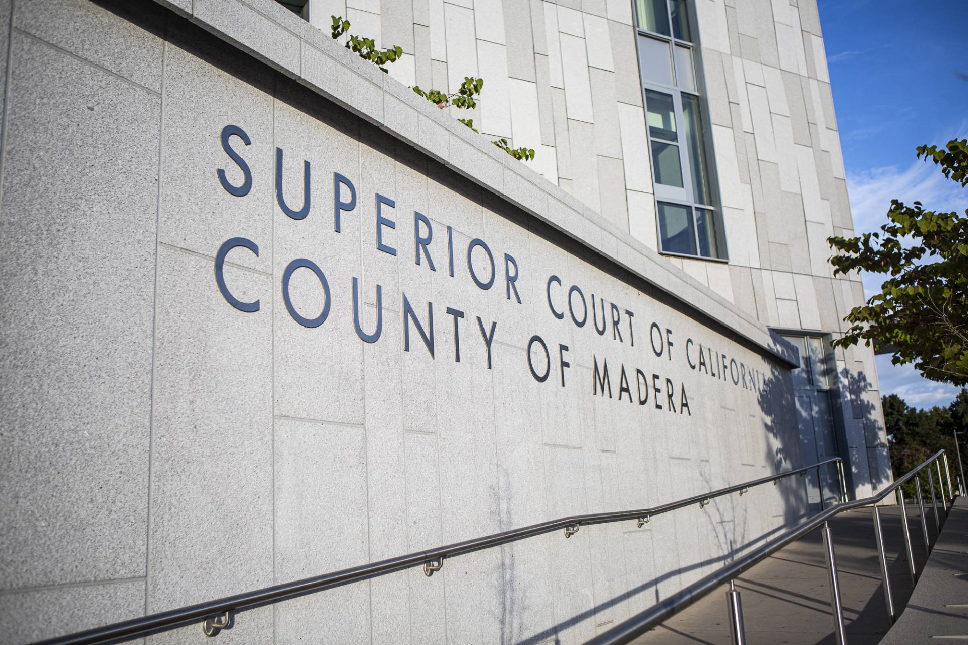 The outside of a building that says "Superior Court of California County of Madera."