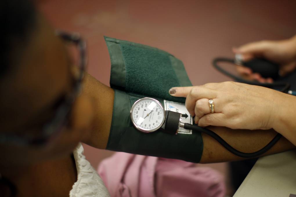 closeup shot of a nurse's hand operating a blood pressure monitoring device