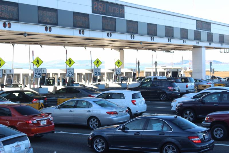 Cars in through the Bay Bridge toll plaza on a busy morning.