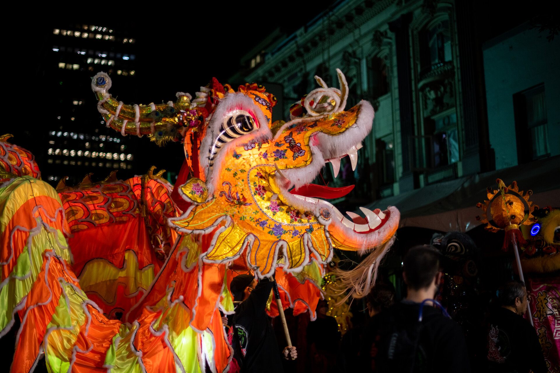A yellow-colored dragon head glows with light against a dark background.