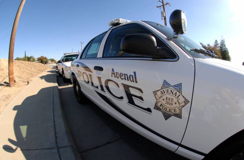 close up view of a police car reading 'avenal police' on the side