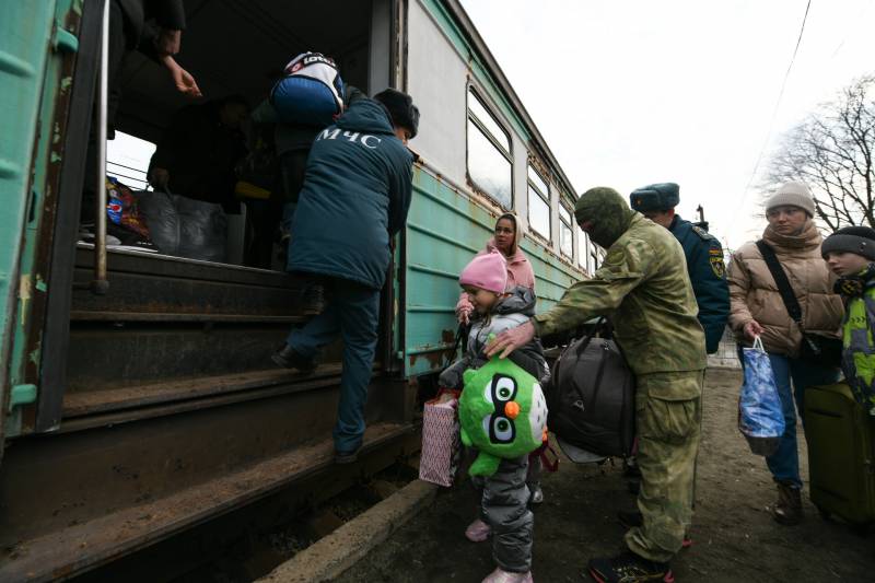 family with children carrying bags stands next to an open door on a passenger train