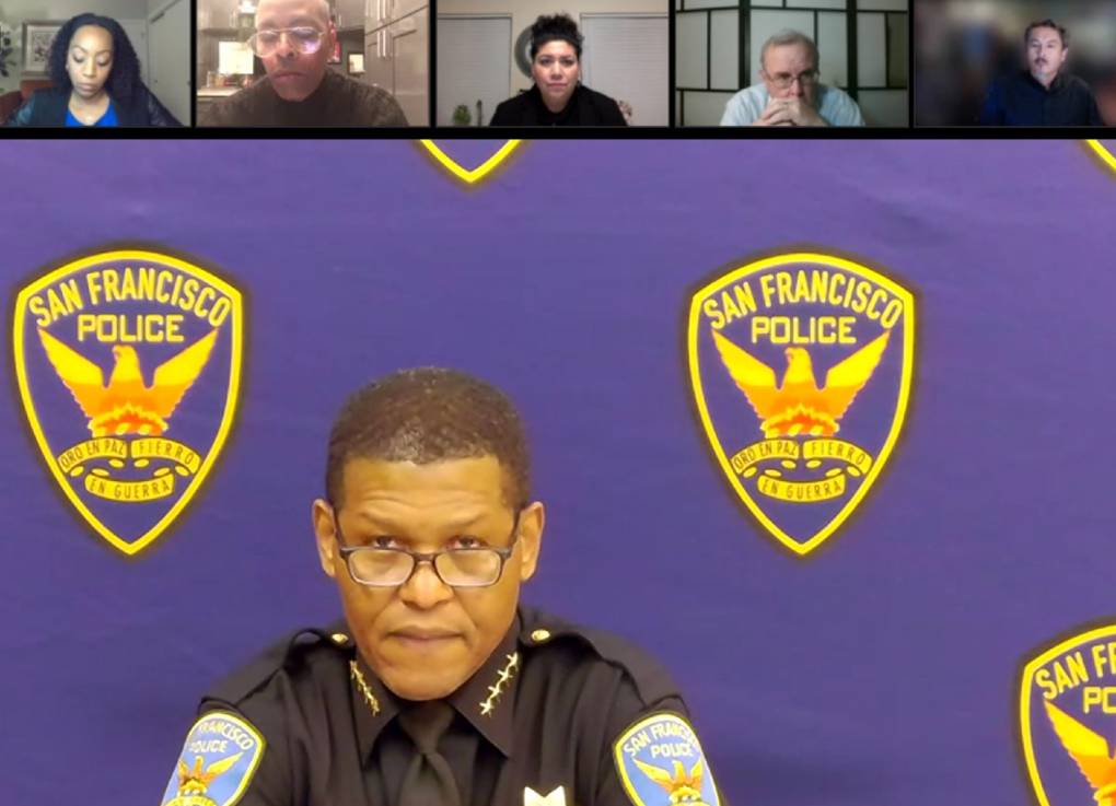 A screen cap from a Zoom call showing a man wearing glasses and police uniform with the "San Francisco Police" logo in the background and other people listening in separate boxes above him.