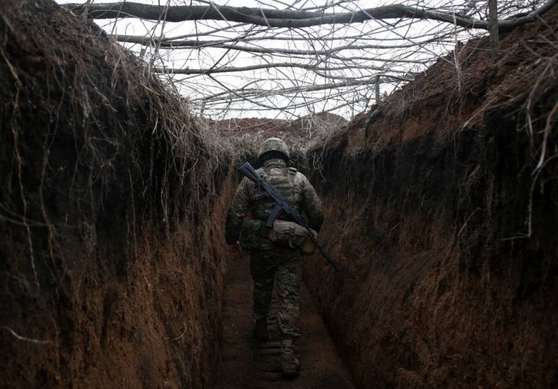 A serviceman of Ukrainian Military Forces walks along trench on his position on the front line with Russia backed separatists not far Novolugansk, Donetsk region on February 16, 2022.