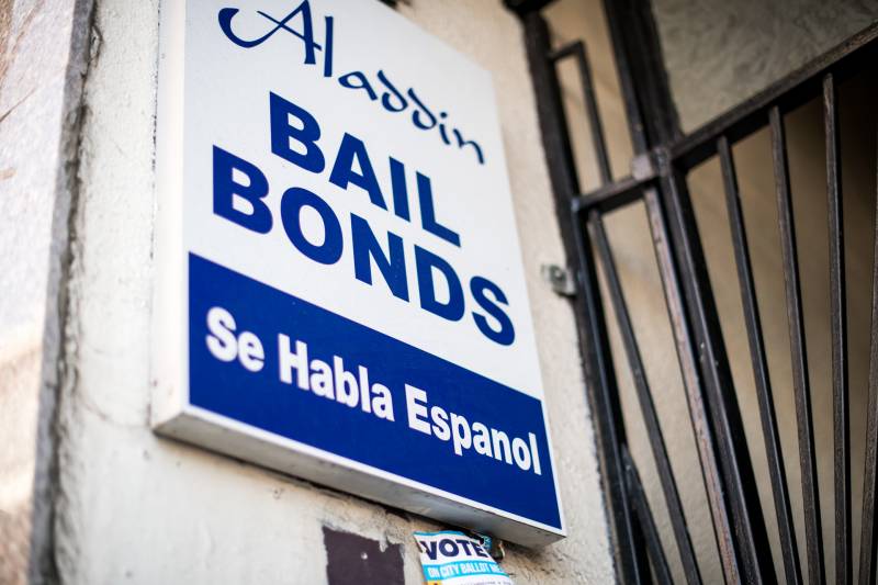 White sign with blue lettering reading 'Aladdin Bail Bonds'