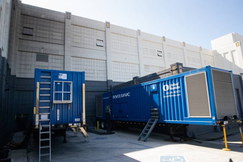 Two giant diesel generators parked outside cannabis production facility in Oakland, California.