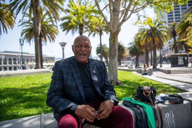 Former A's Pitcher Vida Blue smiles while sitting on a bench