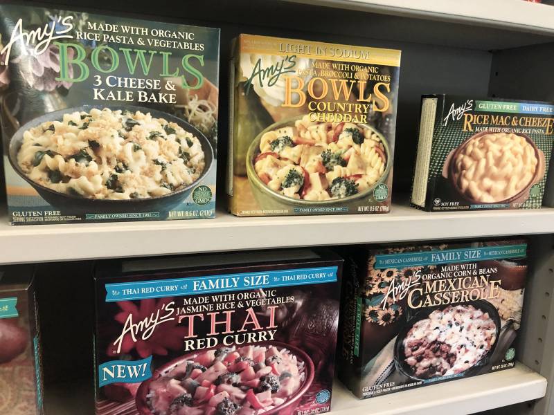 Frozen meal packaging shows bowls of pasta.