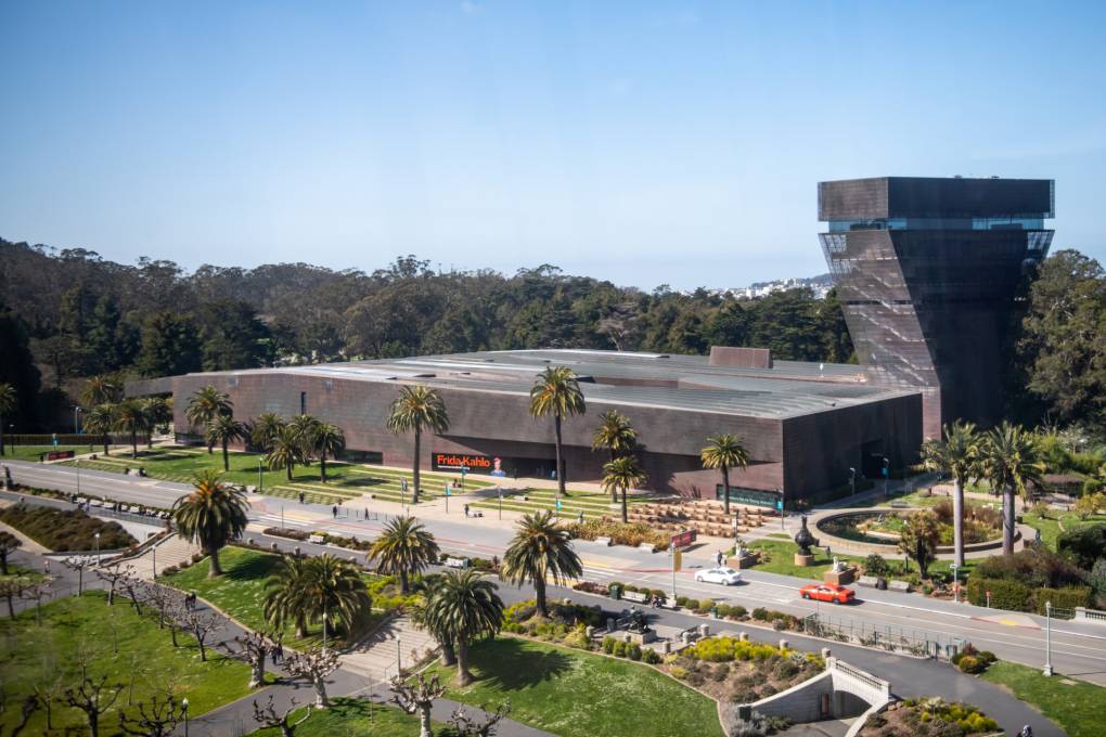 An image of the De Young museum from above during the afternoon. In front of the