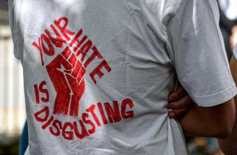 White T-shirt with the message "your hate is disgusting" in red ink.