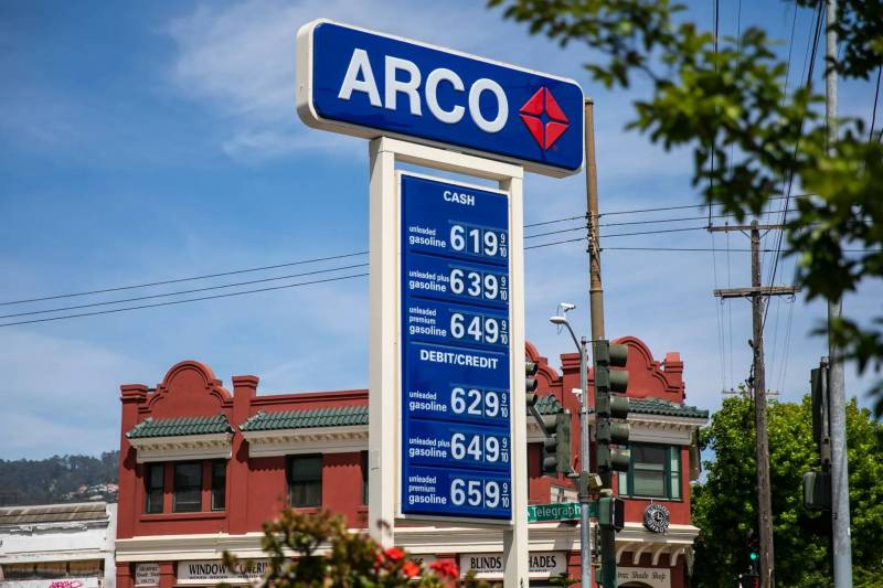At an Arco gas station, a blue and white sign shows how prices start at $6:19 per gallon and go up to $6.59 per gallon.