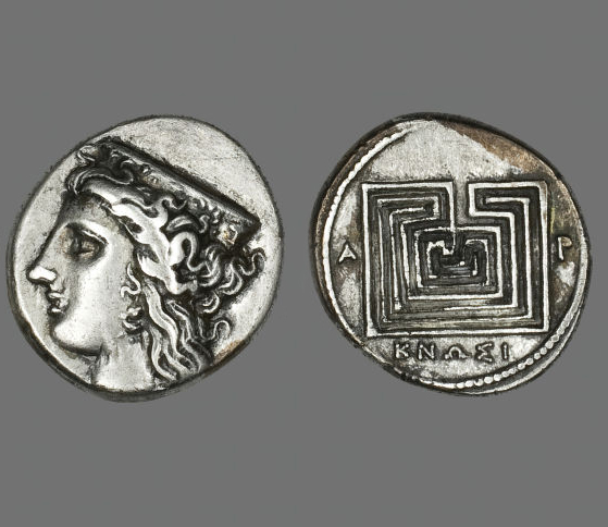 The front and back of an ancient Greek silver coin. On the front is a profile of the goddess Hera. On the back is the design of a classical style square, seven circuit labyrinth. 