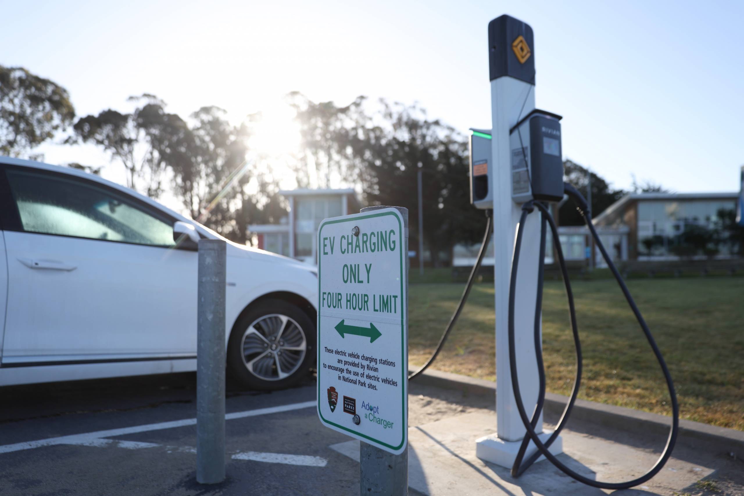 an electric car charges at a charging station 