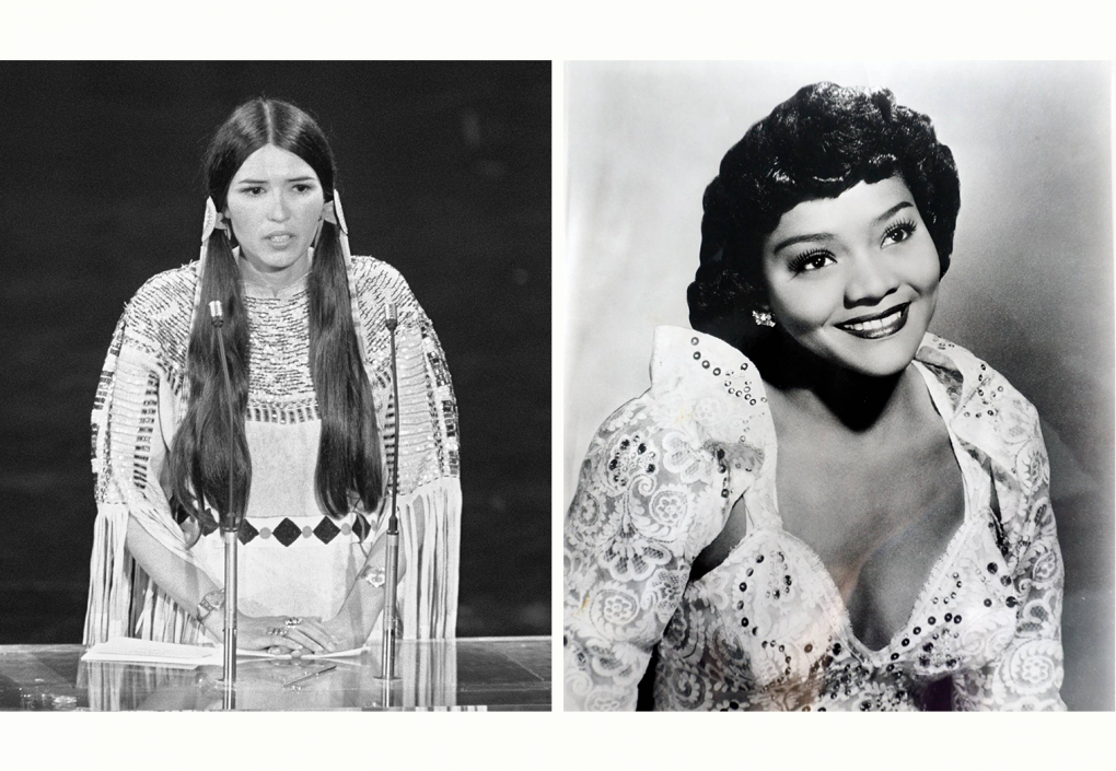 Two woman appear in the image. On the left is a Native American woman wearing a buckskin dress with elaborate beading around the collar and arms, her hair held clasped on each side of her head in two beaded bands. On the right is a Black woman with dark curly hair wearing a white gown with a sweetheart neckline, embroidered in patterns of spirals and petals and studded with jewels. Her face glows with a brilliant smile and her eyes sparkle.