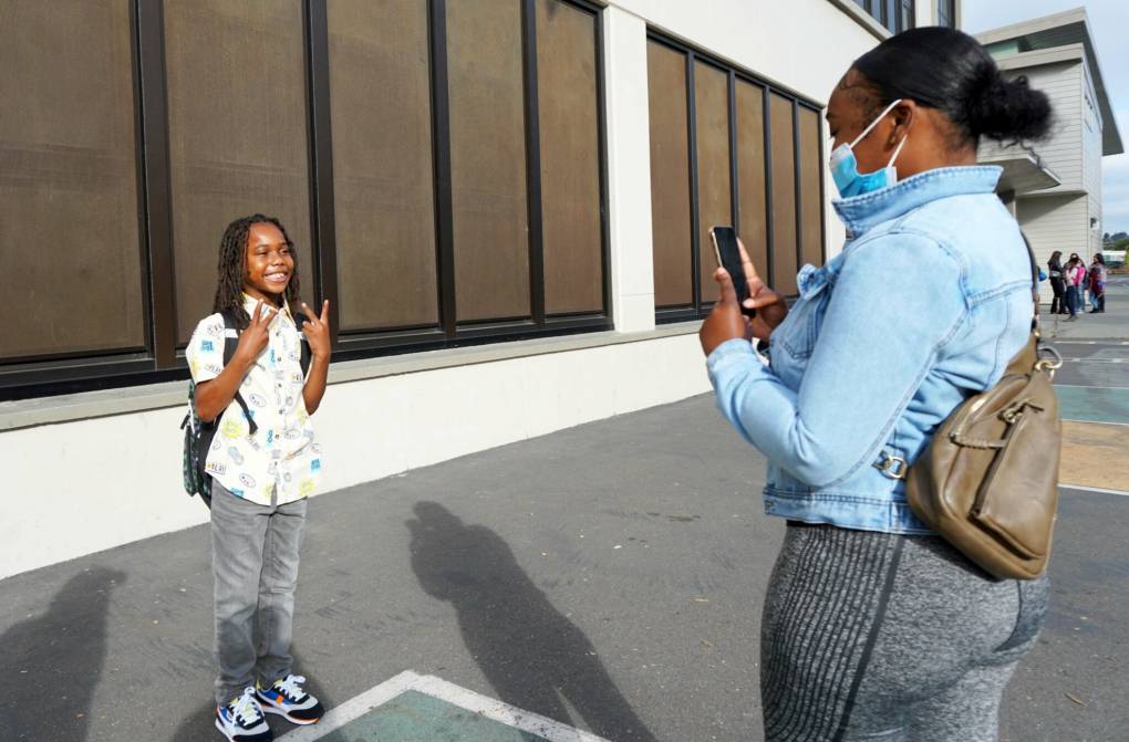 Jameela Jackson snaps a photo of her son Shadeede, a third grader, at Markham Elementary in Oakland Unified on Monday.