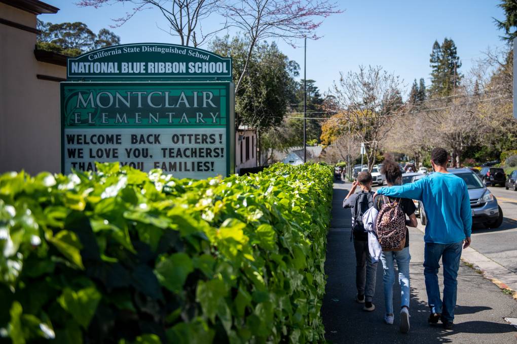 Families pick up their children from Montclair Elementary School on the first day back to in-person learning on March 30, 2021.