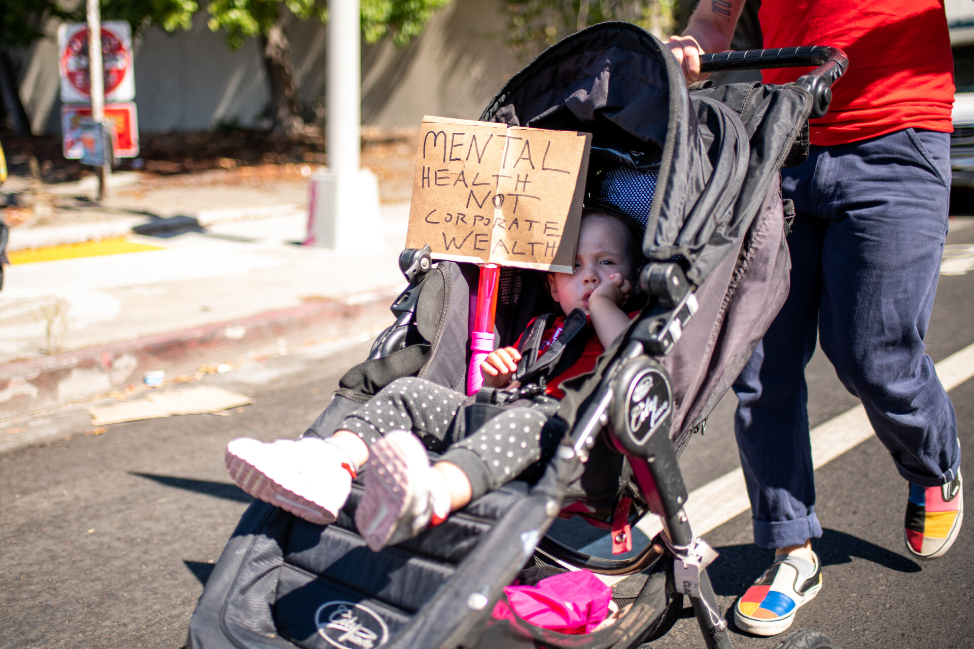 a baby in a stroller as part of a protest 