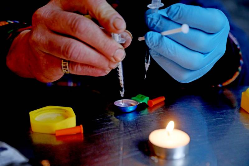 Geoffrey Bordas, 37, of Ontario, a fentanyl addict who also works at the Overdose Prevention Society (OPS), prepares an injection of fentanyl to be given to himself at OPS in the Downtown Eastside (DTES) neighborhood on Tuesday, May 3, 2022 in Vancouver, British Columbia.