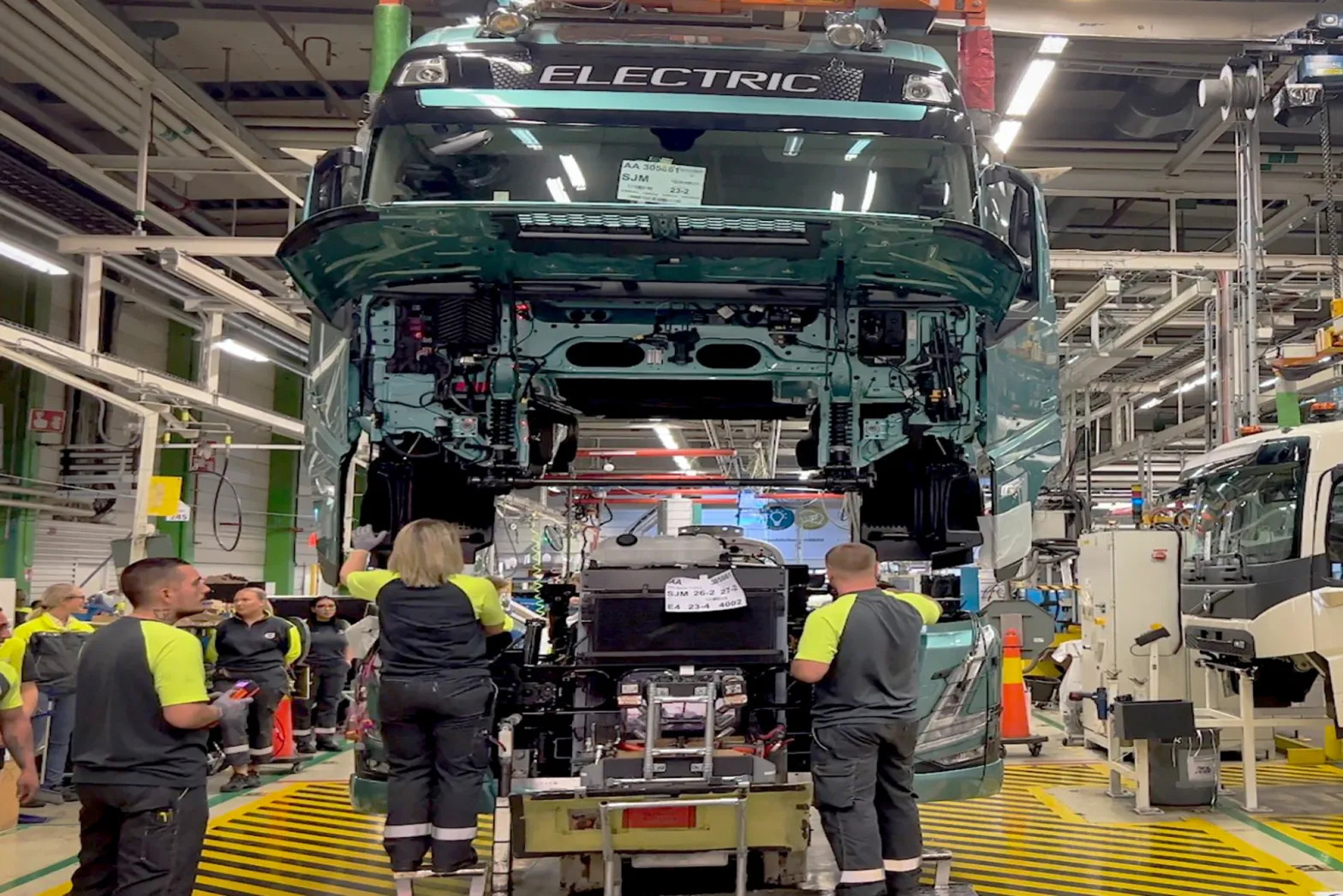 workers at a car factory manufacture an electric truck