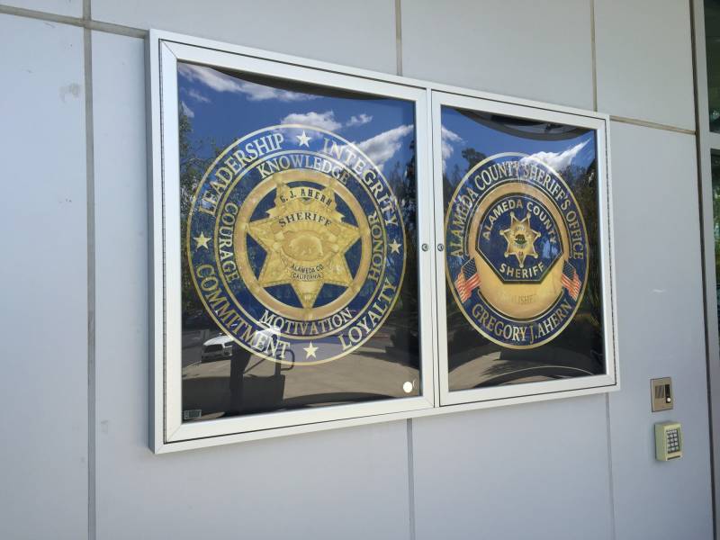 Photo of two large badges behind a display window with the words 'loyalty, leadership and integrity'