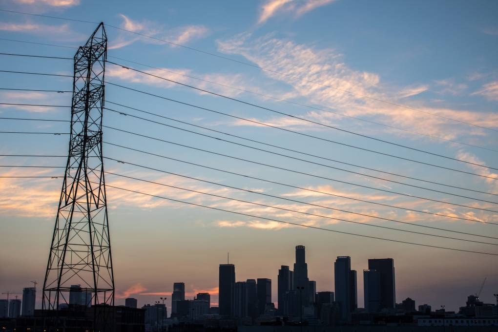 Los Angeles skyline with sunset in the background and power lines in the foreground