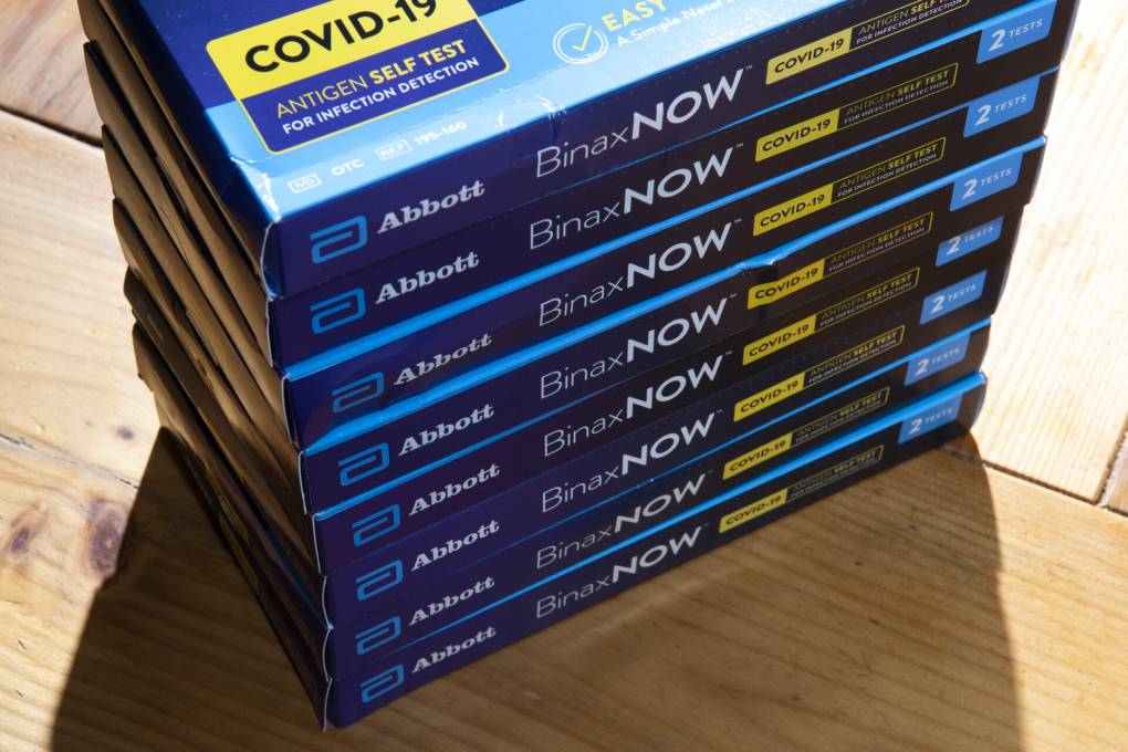 A stack of BinaxNow COVID-19 at-home test kits. Nathan Howard/Getty Images