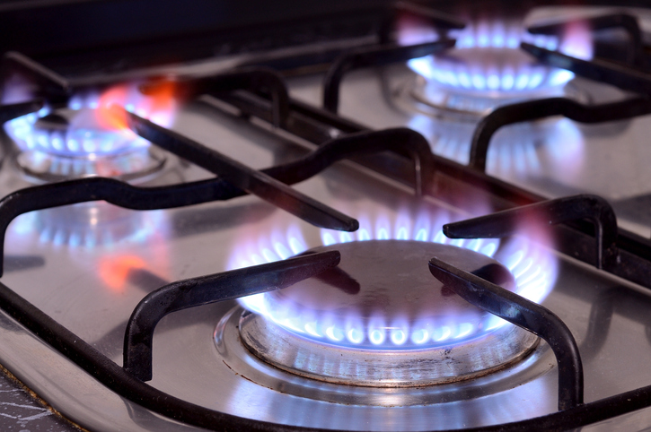 Three flaming ranges on a gas stove.
