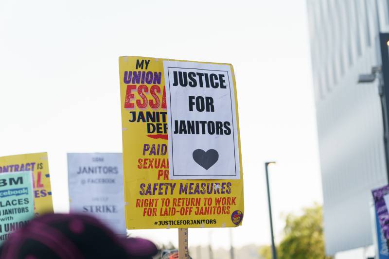 A picket sign that reads "Justice for Janitors"